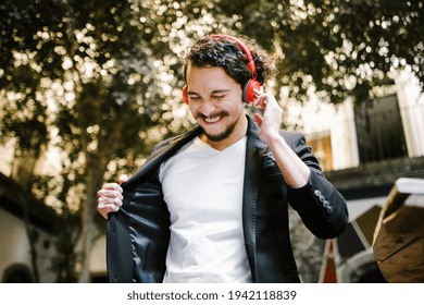 Latin Man With Headphones Listening Music Outdoors In Latin America