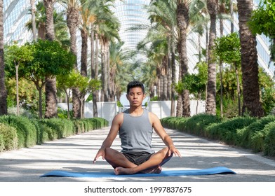 Latin Man Meditating With Tropical Background