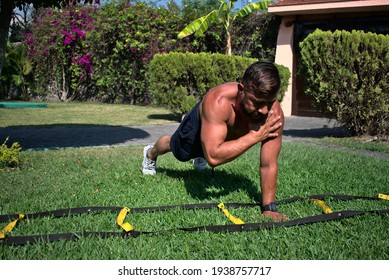 Latin Man Performing Push-ups With Shoulder Tap