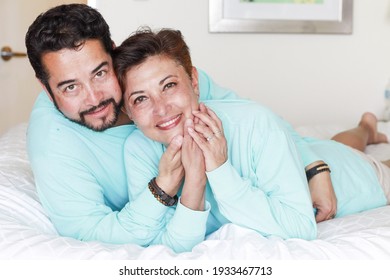 Latin Mature Couple Looking At Their Cellphone 