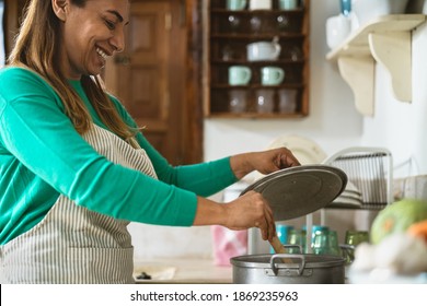 Latin Mature Woman Cooking In Old Vintage Kitchen - Smiling Mother Preparing Lunch At Home 