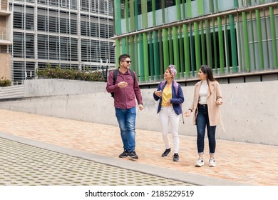 a Latin mid adult man talking to two women while walking on the street - Powered by Shutterstock