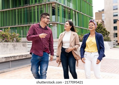 A Latin Mid Adult Man And Two Women Laughing While Walking In The Pedestrian