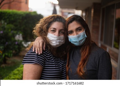 Latin Mother And Daughter Hugging Each Other With Masks Covid19