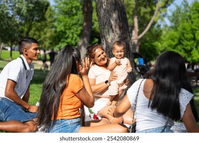 Latin multigenerational family spending a sunny day together in a park - Powered by Shutterstock