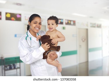 Latin Pediatrician At The Hospital With A Beautiful Baby