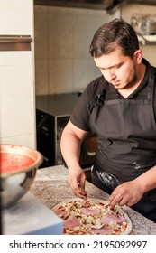 Latin Pizzeria Chef Cook Pizza In Professional Uniform. Restaurant Italian Cuisine Entrepreneur