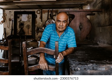 latin senior man carpenter working on wood chair at the furniture workshop in Mexico Latin America, hispanic worker in carpentry - Powered by Shutterstock