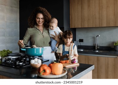 Latin single mother cooking with child daughter and baby at kitchen in Mexico Latin America, hispanic family - Powered by Shutterstock