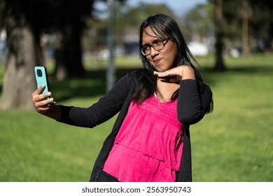 Latin transgender woman taking a selfie in the park - Powered by Shutterstock