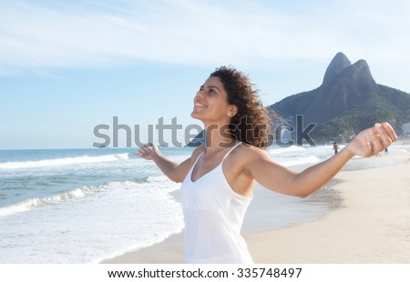 Latin woman at beach enjoying the air