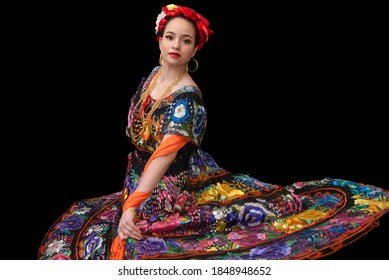 Latin woman dressed as Chiapas with a costume embroidered with flowers, a bow braid and a shawl, Mexican dancer, multicolored traditional folklore