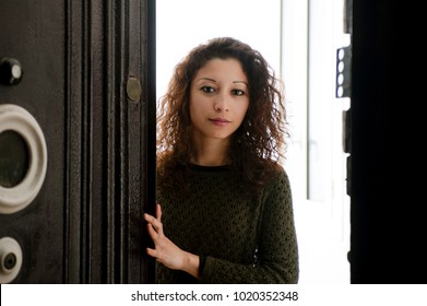 Latin Woman Opening The Front Door, White Inside