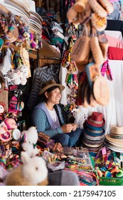 Latin woman smiling at her job in a typical souvenir store in South America - Shutterstock ID 2175947105