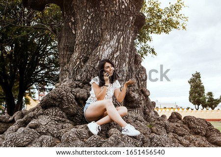 latin woman talking on smart phone in Mexico city, Mexican girl