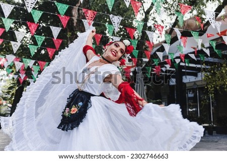 Latin woman wearing traditional Mexican dress traditional from Veracruz Mexico Latin America, young hispanic people in independence day or cinco de mayo parade or cultural Festival