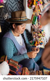 Latin Woman Weaving With Wool In A Handicraft Store In South America