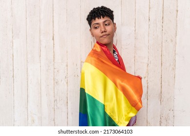 Latin woman wrapped in pride flag