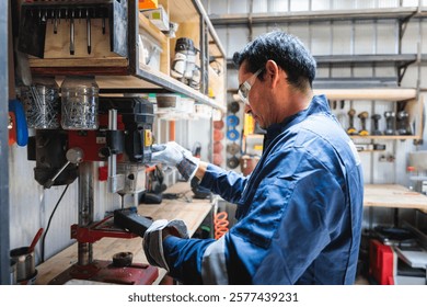 Latin worker using drill press in workshop