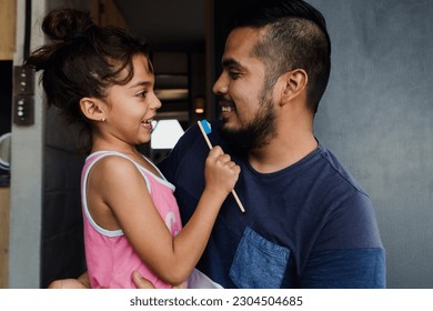 latin young father teaching to his daughter how to brush teeth at home in Mexico Latin America, hispanic family  - Powered by Shutterstock