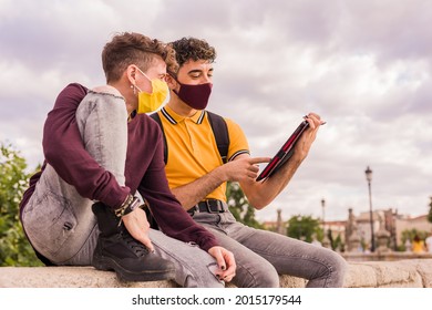 Latin young man and non binary transgender friends using technology for social distance in new normal - Powered by Shutterstock