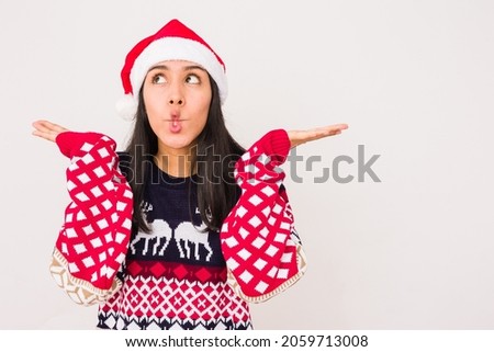 Latin young woman funny with a ugly sweater. xmas celebration on withe background