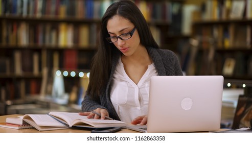 Latina College Student Works On Laptop At The Library