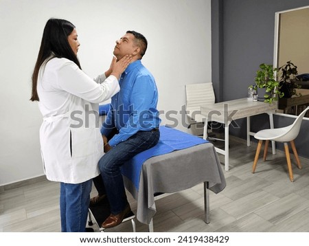 Latina female doctor checks dark-skinned male patient in office for sore throat due to viruses, bacteria, allergies and smoking