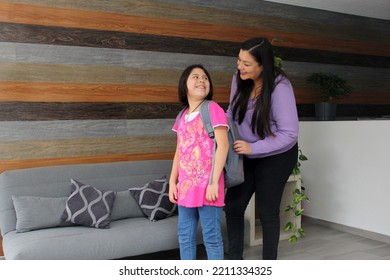 Latina Mom Checks Her Hispanic Daughter's Backpack For Safety Before Going To School To Make Sure She Doesn't Bring Weapons, Drugs Or Dangerous Things
