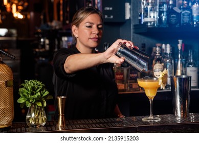 Latina Prepares A Cocktail At A Bar Counter. Job Waitress Profession
