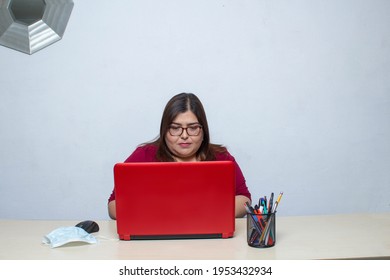 Latina Teacher Working From Home Making Video Call Next To Face Mask For The New Normal. Fat Model