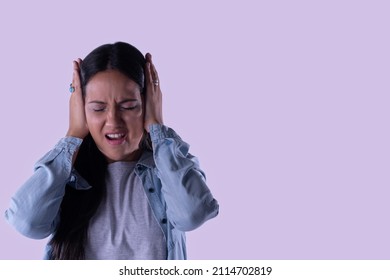 Latina woman closes her eyes and covers her ears. Against domestic sexual violence
