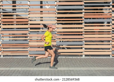 Latina Woman Running Outdoors, Healthy Lifestyle. Yellow Color