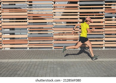 A Latina Woman Running In A Race. Healthy Living. Female Runner.