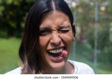 Latina Woman Smiling And Showing Tongue. Fresh Air