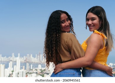 Latina Woman Walking Down The Street With A Friend