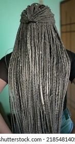 A latina young woman with long hair with box braids hairstyle. An African girl with dreadlocks
