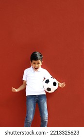 Latino 8-year-old Boy Plays With A Soccer Ball Very Excited That He Is Going To See The World Cup And Wants To See His Team Win
