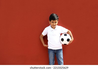 Latino 8-year-old Boy Plays With A Soccer Ball Very Excited That He Is Going To See The World Cup And Wants To See His Team Win
