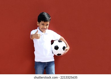 Latino 8-year-old Boy Plays With A Soccer Ball Very Excited That He Is Going To See The World Cup And Wants To See His Team Win
