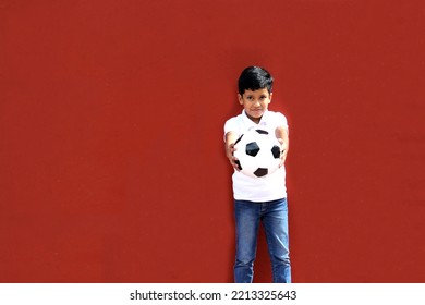 Latino 8-year-old Boy Plays With A Soccer Ball Very Excited That He Is Going To See The World Cup And Wants To See His Team Win
