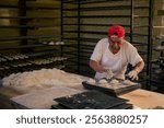 Latino baker in his artisanal bakery, making bread to sell.	