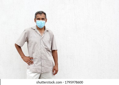 
Latino elderly with protective face masks on white wall background, new normal covid-19