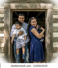 Latino family centered near a door, posing
