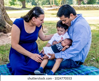 Latino family at the park with their children