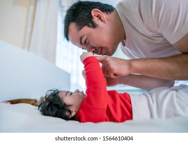 Latino father playing and taking care of his beautiful firstborn son - Shutterstock ID 1564610404