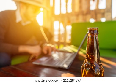 Latino Hipster In A Bar Drinking Beer While Working Online