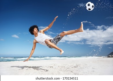 Latino Hispanic Man Doing Bicycle Kick On Beach With Soccer Ball