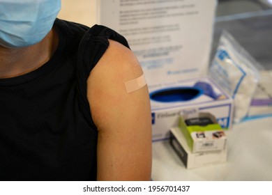 Latino Male With Band Aid On Shoulder After Receiving Covid-19 Vaccine.