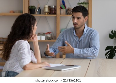Latino male company position candidate answers questions during job interview in office, female recruiter listen to applicant. Staffing, business meeting of client and manager, human resources concept